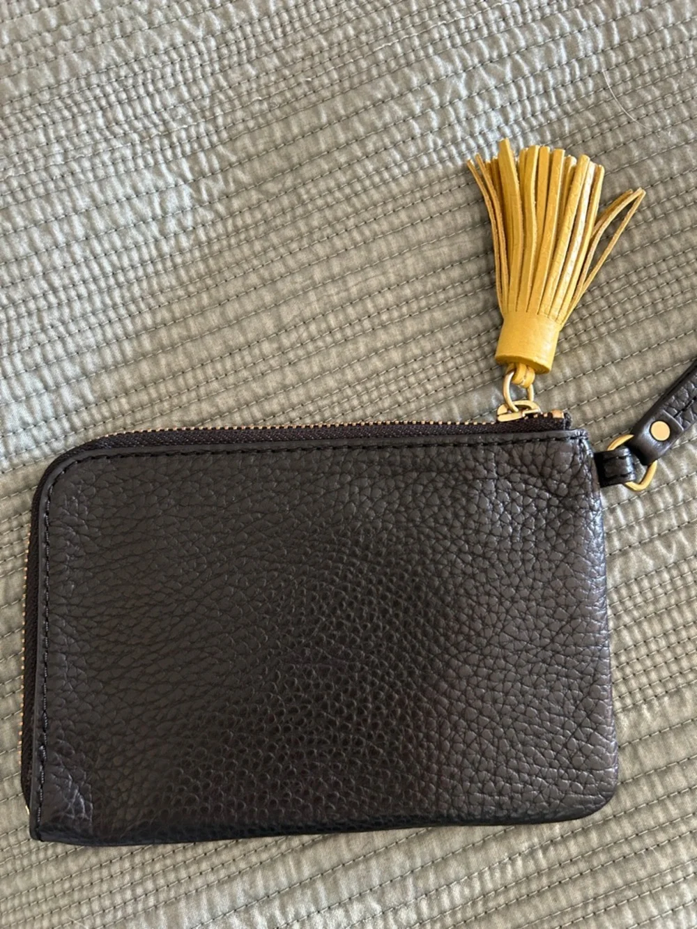 Fossil Tara Black Pebbled Leather Wristlet with Yellow Tassel Accent